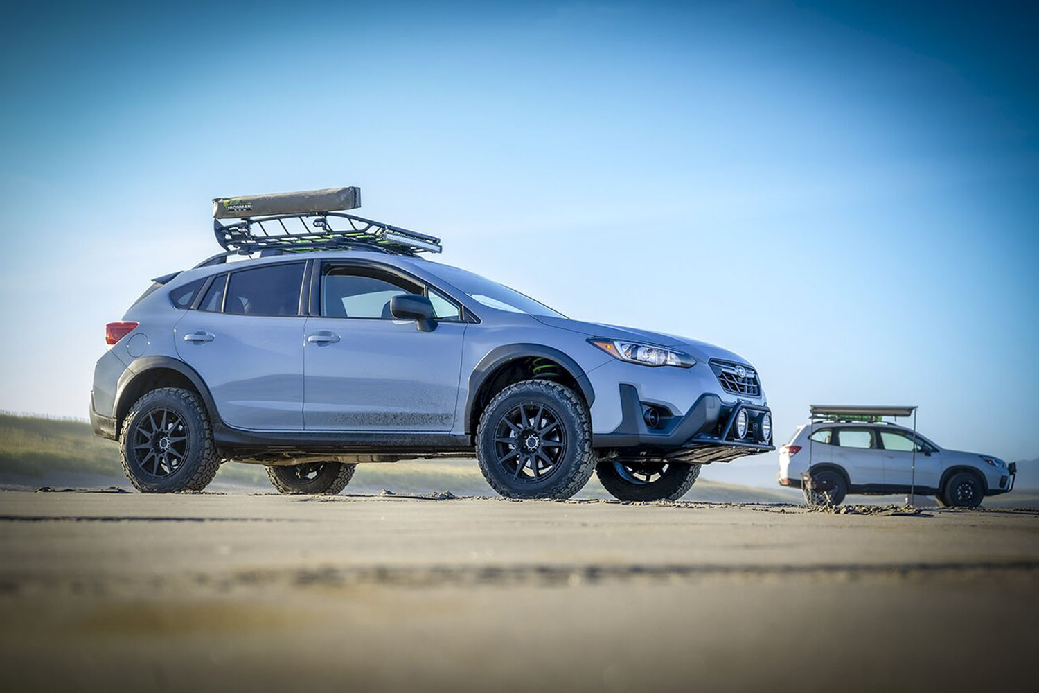 What is the wheel and tire setup on the lifted Subaru Crosstrek in all the photos?